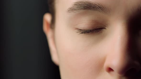 Extreme Close Up of Half Face Shot of Serious Female Face Indoors