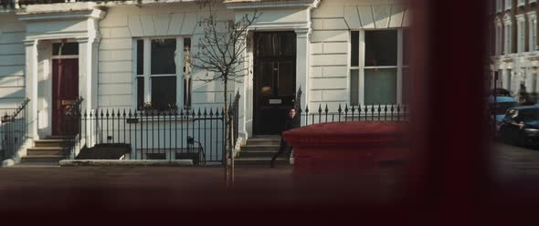 Young girl coming out of the building and walking excited to the street