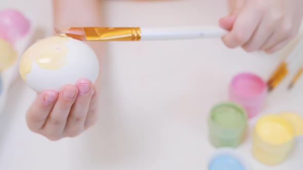 A Lefthanded Child Paints Eggs for Easter