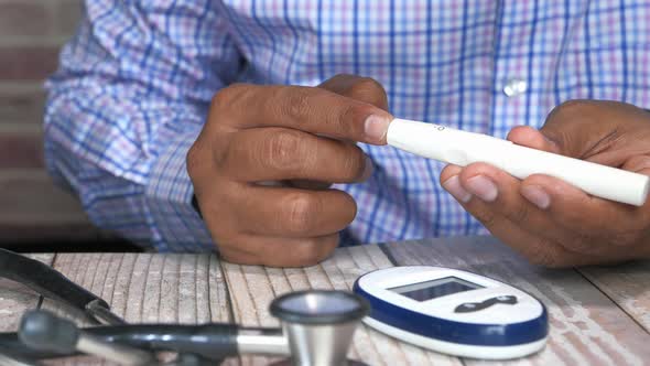 Man's Hand Measuring Diabetic on Table 