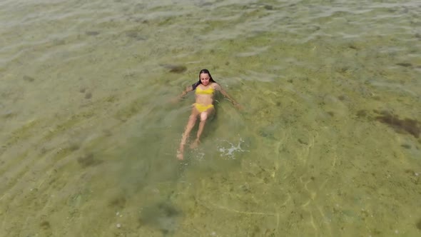 Aerial View Woman in Bikini Swimming in Calm Sea