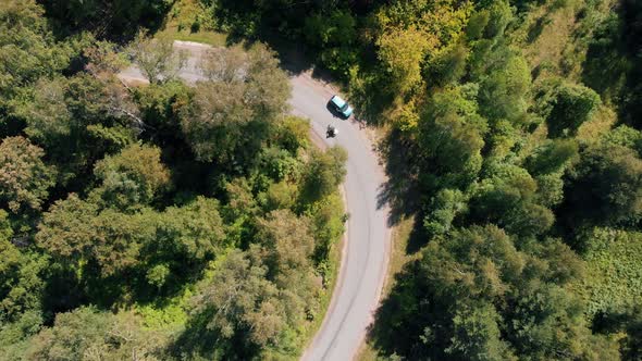 Two Motorcyclists Riding a Motorbikes in the Forest