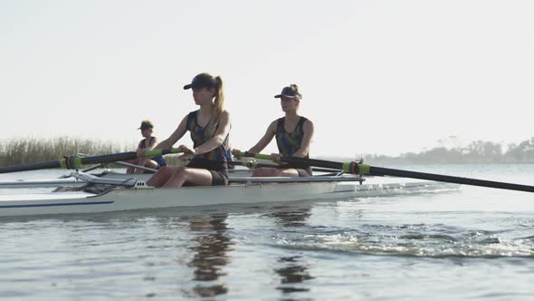 Female rowing team training on a river