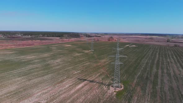 Electricity pylon and power lines in field. Energy substation. Power lines from bird eyes view