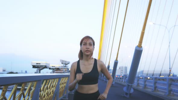 Young Athlete Running on Bridge