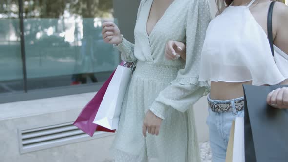 Cropped View of Two Women Walking and Shopping Together