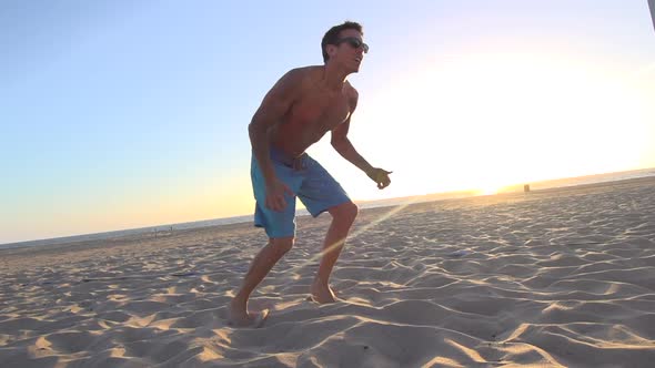 Men playing beach volleyball.