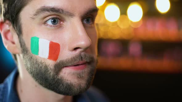 Nervous Bearded Male Fan With Italian Flag on Cheek Making Facepalm, Team Losing