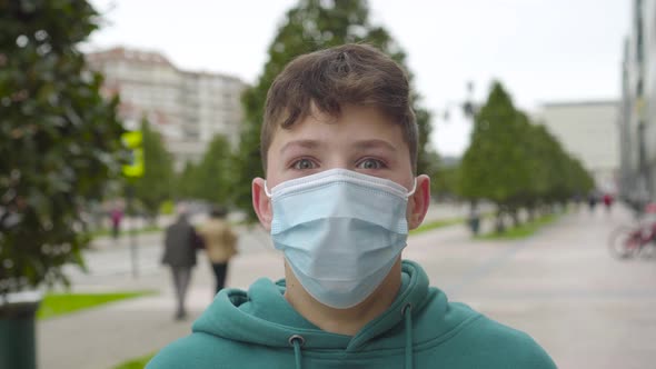 A positive young man is shocked in a medical protective mask