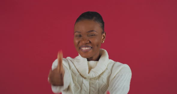Happy Ethnic Model African American Woman Stands Isolated on Red Background Posing Showing Thumbs Up