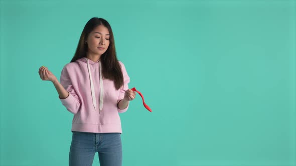 Asian Girl Popping Balloon Isolated on Background