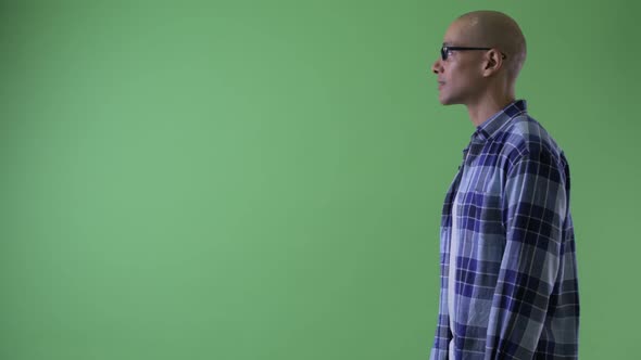 Profile View of Happy Bald Hipster Man Pointing Finger