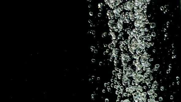 Falling Raindrops Footage in Slow Motion on Black Background. Falling Water Droplets Against Black