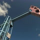 Low Angle View of Oil Pump Jack Working and Pumping Crude Oil Under Blue Sky - VideoHive Item for Sale