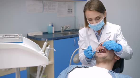 Female Dentist Conducting Tooth Decay Treatment