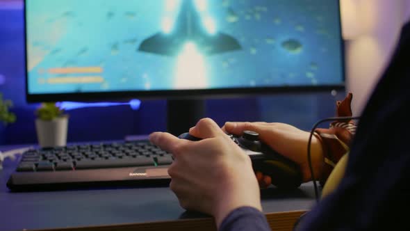 Closeup of Professional Cyber Gamer Playing Space Shooter Video Game