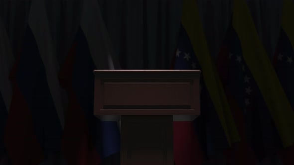 Many Flags of Venezuela and Russia Behind Speaker Tribune