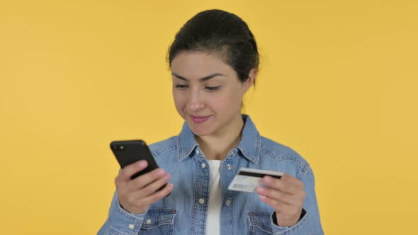 Online Shopping on Smartphone By Indian Woman, Yellow Background 