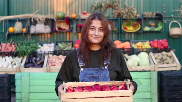 Woman Farmer (Seller) With Apples at the Farmer's Market.