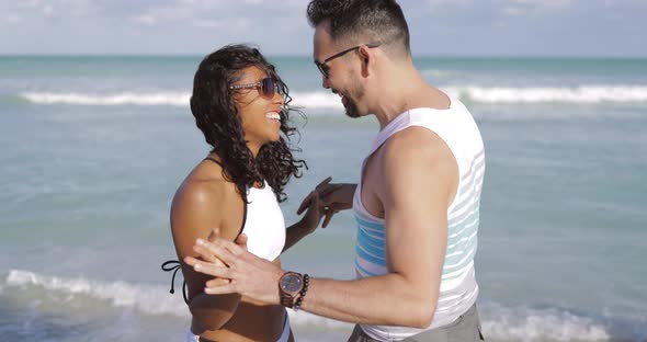 Cuddling Happy Couple on Beach