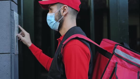 Rider man delivering meal to customers home while wearing face mask during corona virus outbreak