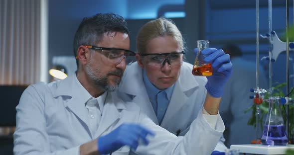 Scientists Examining Various Liquids