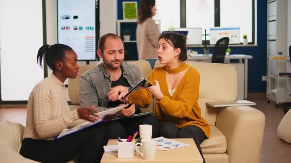 Diverse Businesspeople Analysing Financial Project During Corporate Meeting