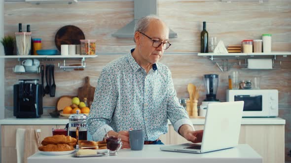 Senior Man Working on Laptop