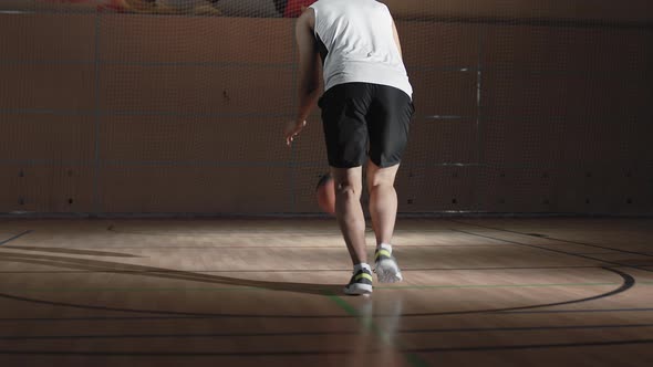 Player Shooting Basketball on Indoor Court