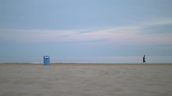 Jogger Running Beside the Sea on a Cold Day