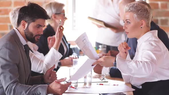 Business Team Is Discussing a Project at a Large Office Table. Creative Office Interior.