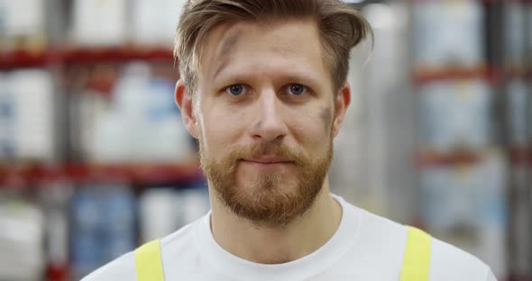 Close Up Portrait of Professional Industry Worker with Dirty Face in Factory or Warehouse