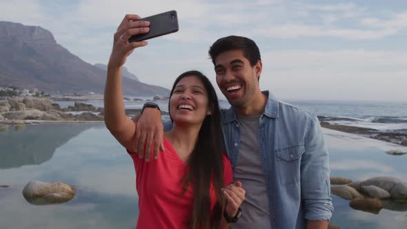 Young couple taking selfies