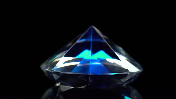 Diamond Is Spinning and Shimmering with Dark Blue Color. Black Background