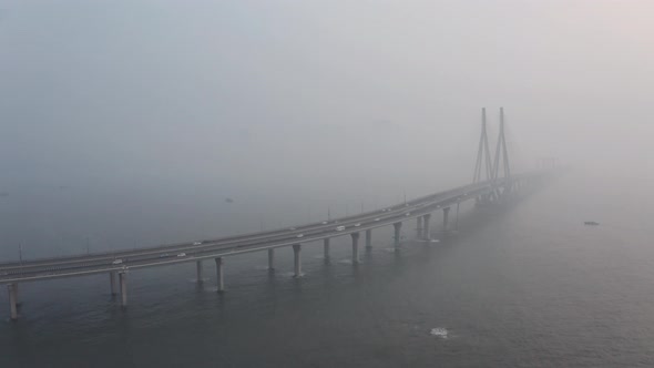 Drone shot towards large suspension bridge bandra worli sealink Mumbai on a hazy day