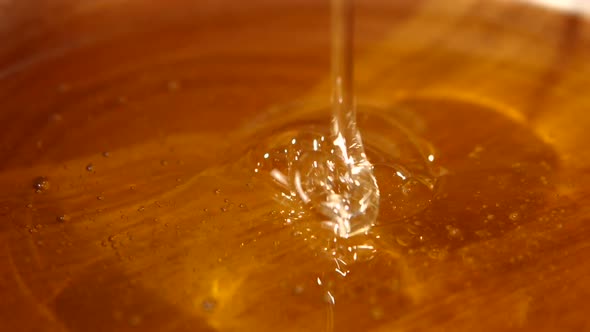 Taking Honey By Using Metal Spoon in Wooden Bowl, Flowing Down, Close Up