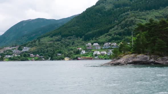 An Island in the Sea Against the Background of Fjords