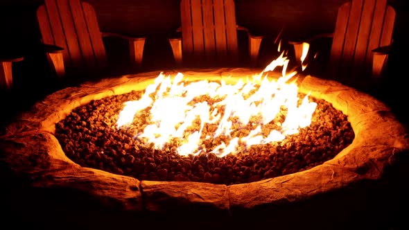 Chairs arranged around a cozy backyard fire pit