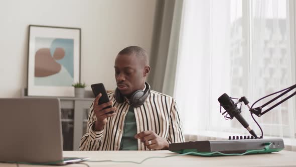 African Musician Playing Midi Synthesizer while Having Video Call