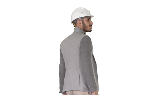 Walking engineer in helmet on white background.