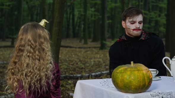 Man with Halloween Vampire Makeup Scaring Girl Grimacing As Kid Trying Scare Mysterious Entity