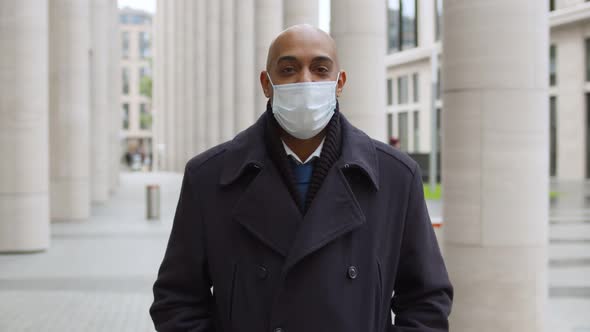 Portrait of Responsible Mature Businessman Wearing Protective Mask Looking at Camera Outdoors