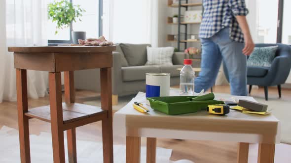 Woman Taking Break While Renovating Table at Home