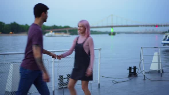 Young Joyful Millennial Couple Dancing on Urban Embankment in the Evening Dating Outdoors
