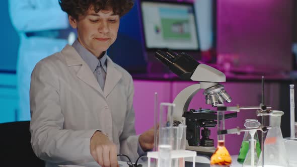 Curly Scientist Posing for Camera alt