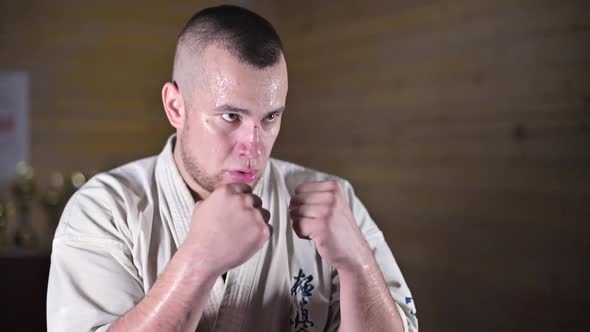 Side view of a karate fighter showing punches practicing in training