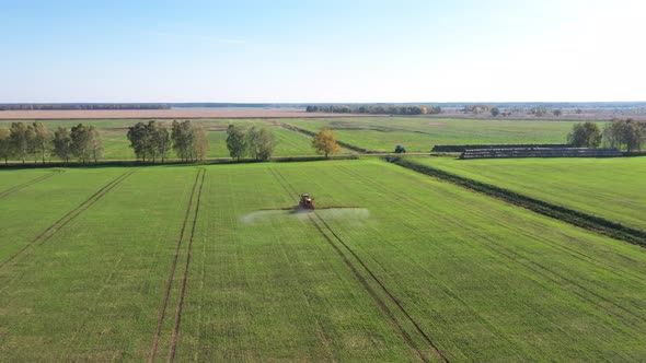 Agricultural Tractor Spraying Herbicides And Pesticides Fertilizer On Field