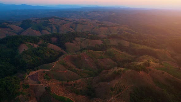 4K aerial view over mountain scenery rural Thailand at sunset