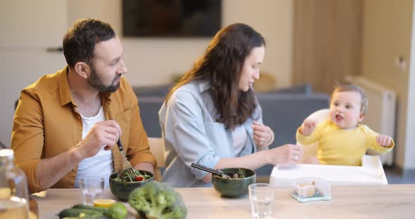 Young Family with a One Year Baby Boy During a Lunch Time at Home