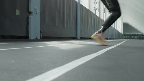 Legs of Athlete with Prosthetic Limb Training Agility